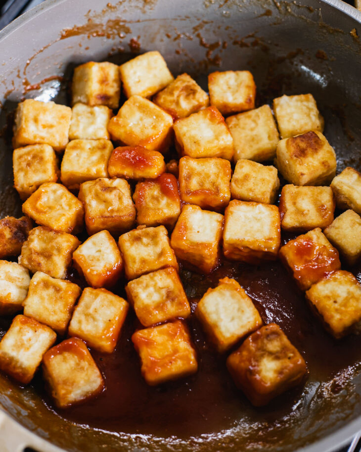 Instruction on how to make sweet and sour tofu - Gently push the tofu back and forth in the sauce.