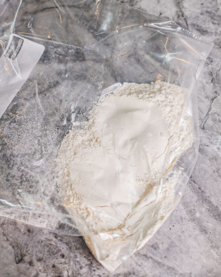 Instruction on how to make sweet and sour tofu - Add flour and starch mix in a large ziplock bag, along with salt.