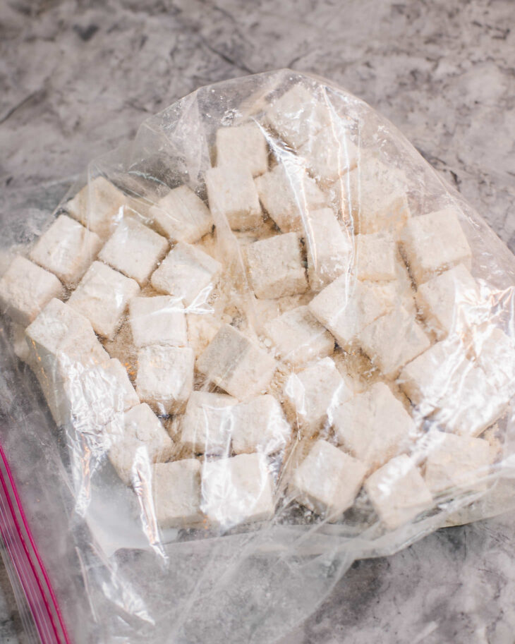 Instruction on how to make sweet and sour tofu - Gently shake the tofu in the bag to make sure they are evenly coated.