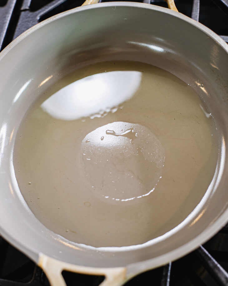 Instruction on how to make sweet and sour tofu - In a non-stick pan, heat neutral cooking oil until shimmering.