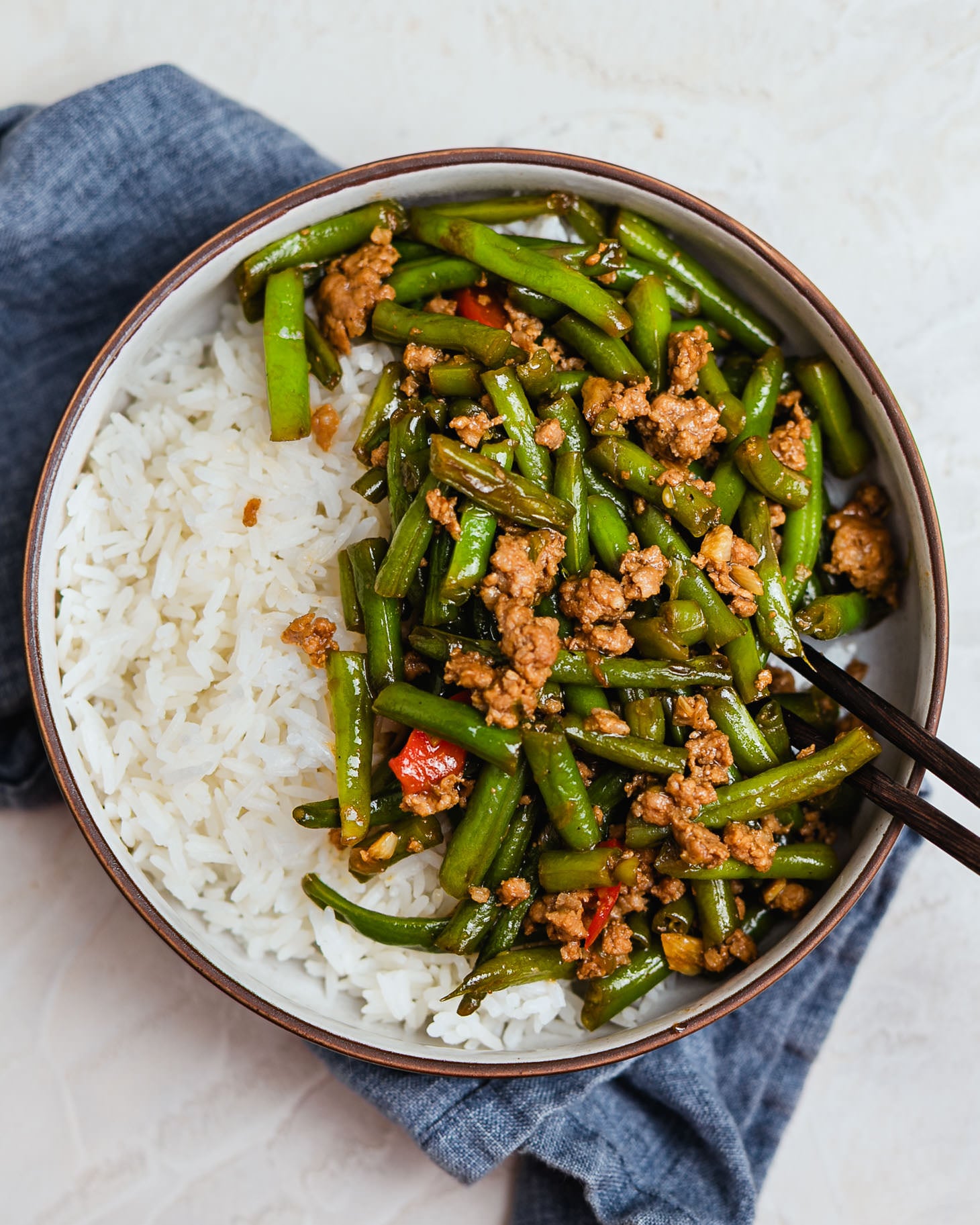 Green beans and pork stir fry with minced pork served over white rice, easy weeknight meal