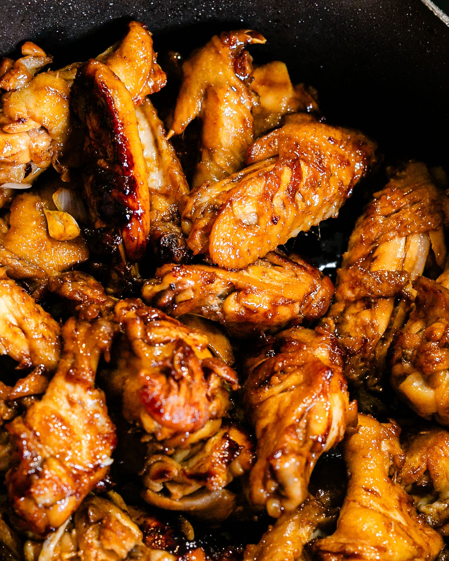Chinese red braised chicken wings (红烧鸡翅) caramelized and simmered until tender in a pot.