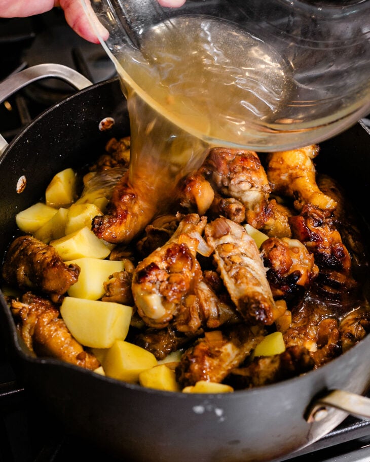 Pour in hot water or broth. Bring to a boil, then cover and simmer over medium-low heat.