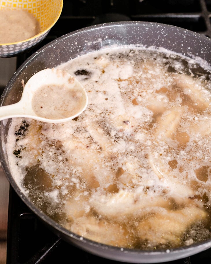 Foam will start floating to the top—use a spoon to skim it off.