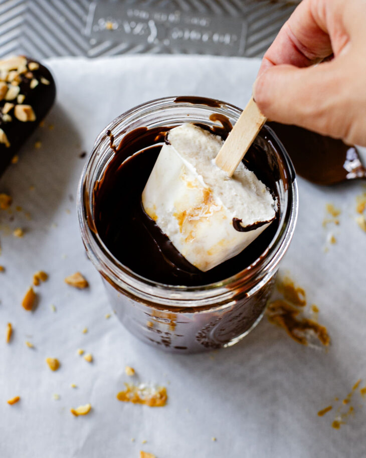 Once the chocolate is slightly cooled. Dip the ice cream bars in.
