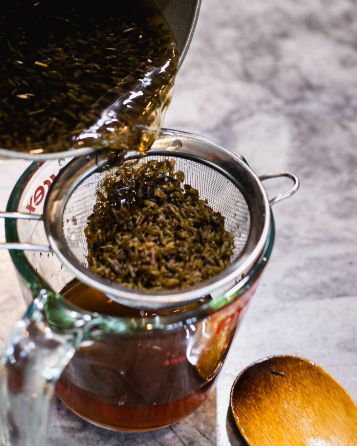 Once cooled, strain out the lavender buds using a fine-mesh strainer.