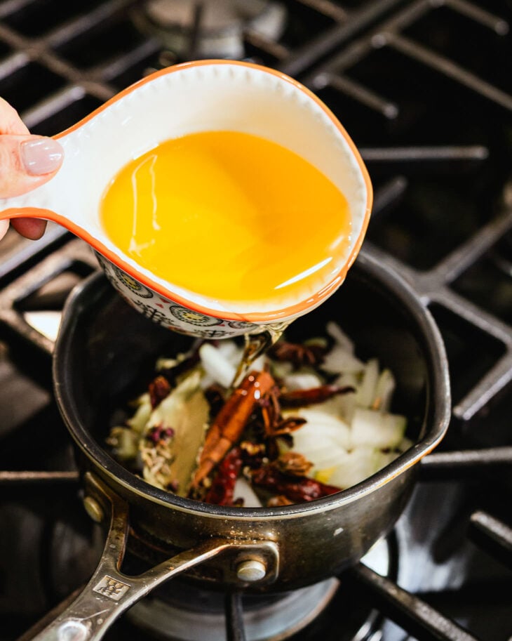add all of the ingredients except the chili flakes, sugar, salt, and coconut aminos (or soy sauce) to a saucepan.