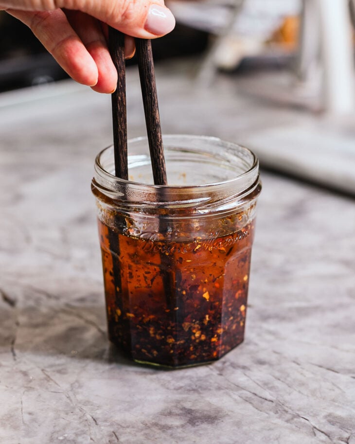 The hot oil will immediately bloom the chili flakes and create a sizzle.
