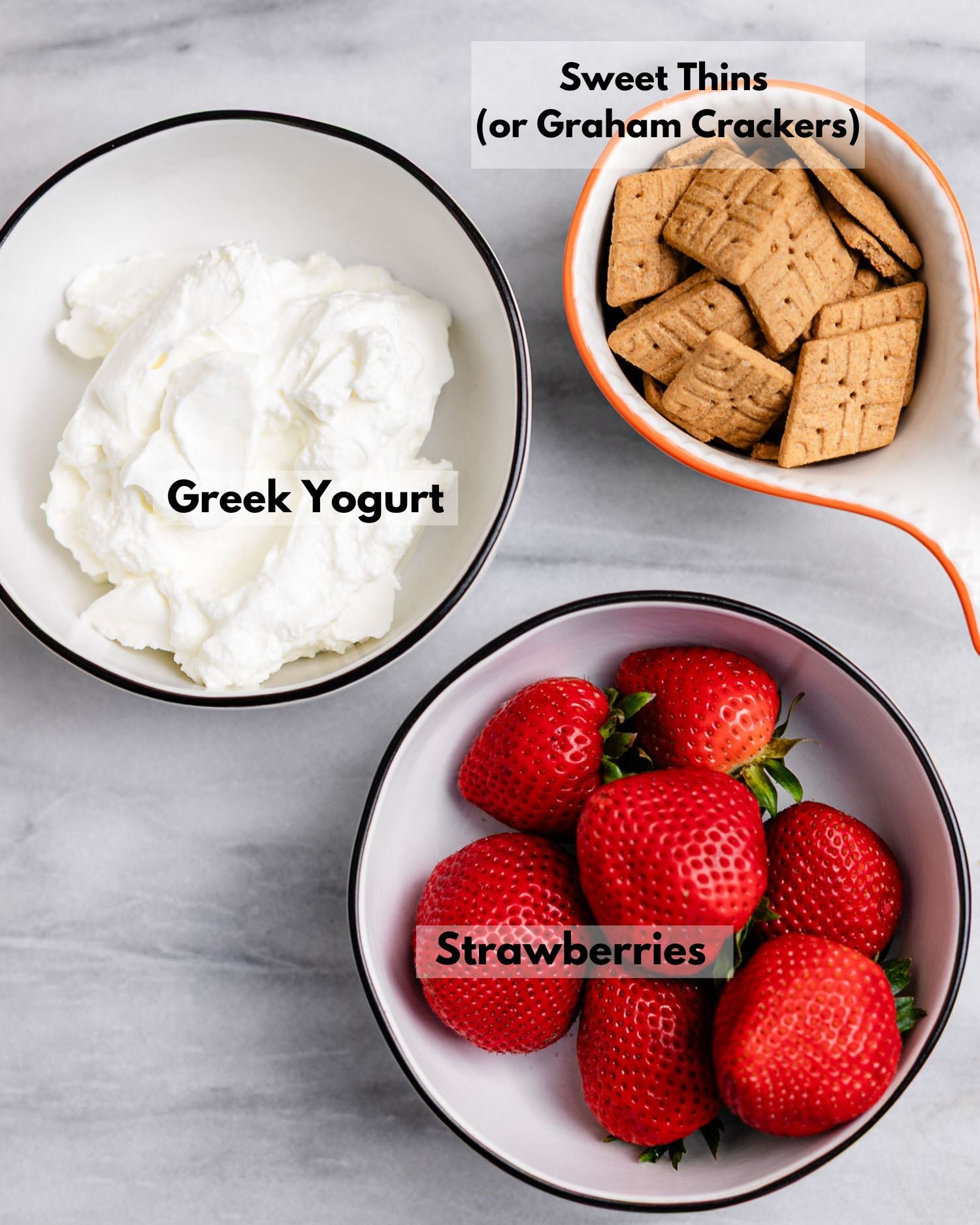 greek yogurt, graham crackers (sweet thins) and strawberries are the 3 ingredients to make this greek yogurt parfait recipe.