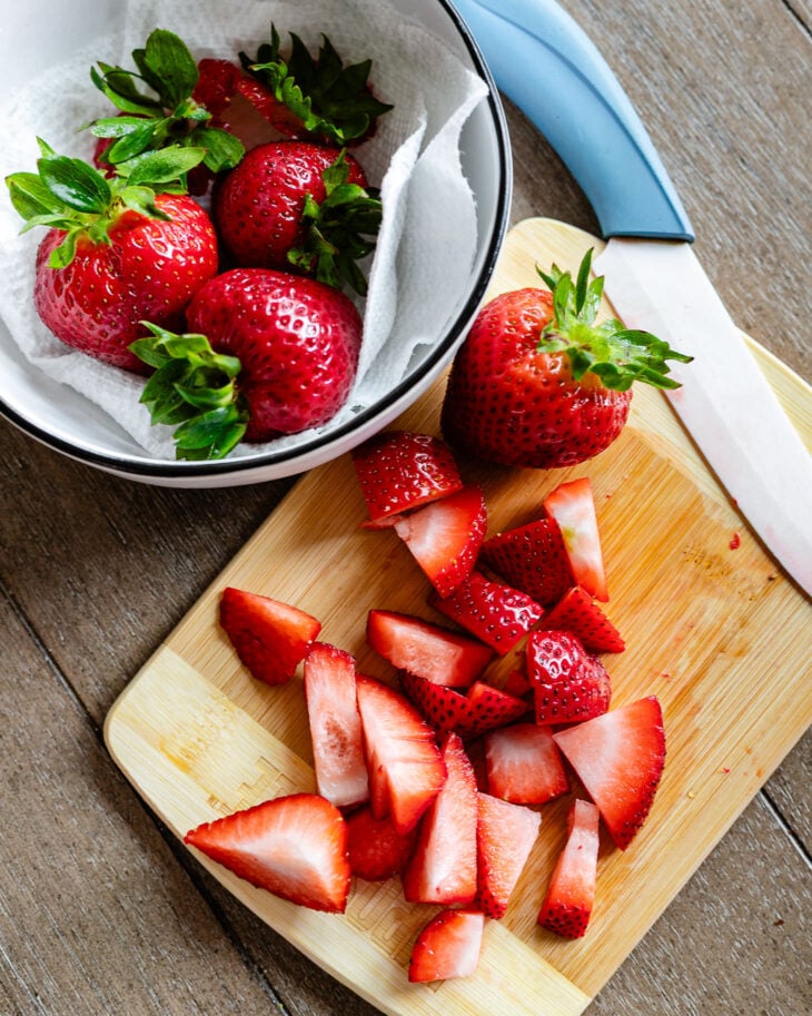 Wash and chop strawberries.