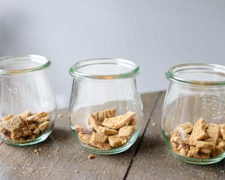 In a jar or container, add a layer of crushed Sweet Thins or graham crackers.