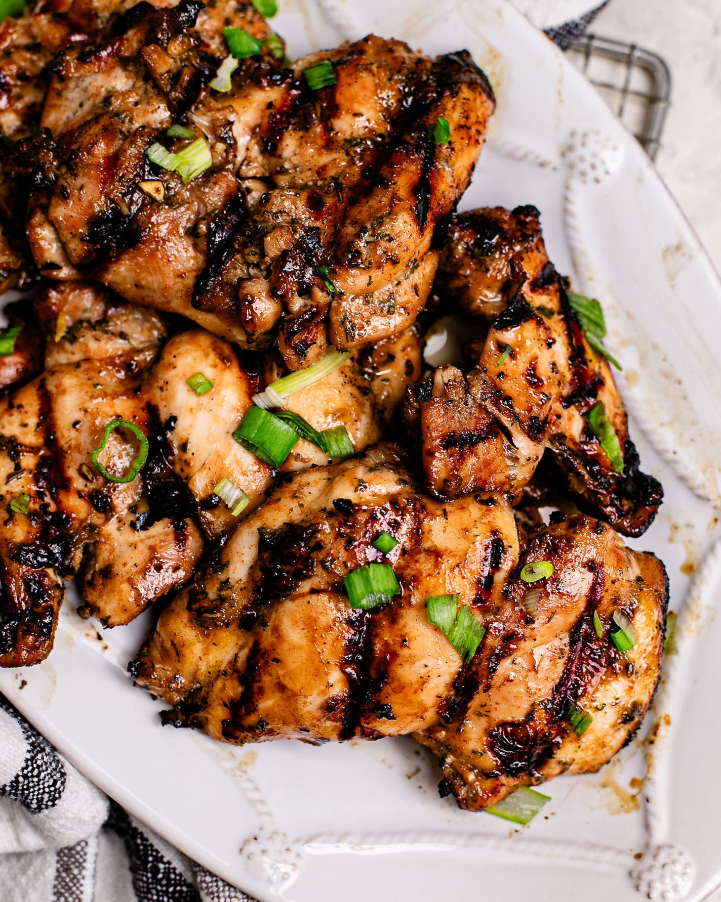 Juicy Asian grilled chicken thighs with caramelized edges, green onions, and a flavorful garlic honey marinade