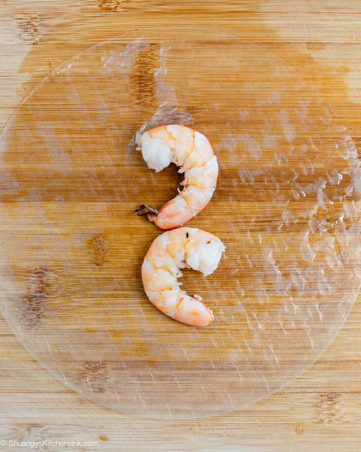 Place the wrapper on a cutting board or clean work surface. Start by layering the shrimp.