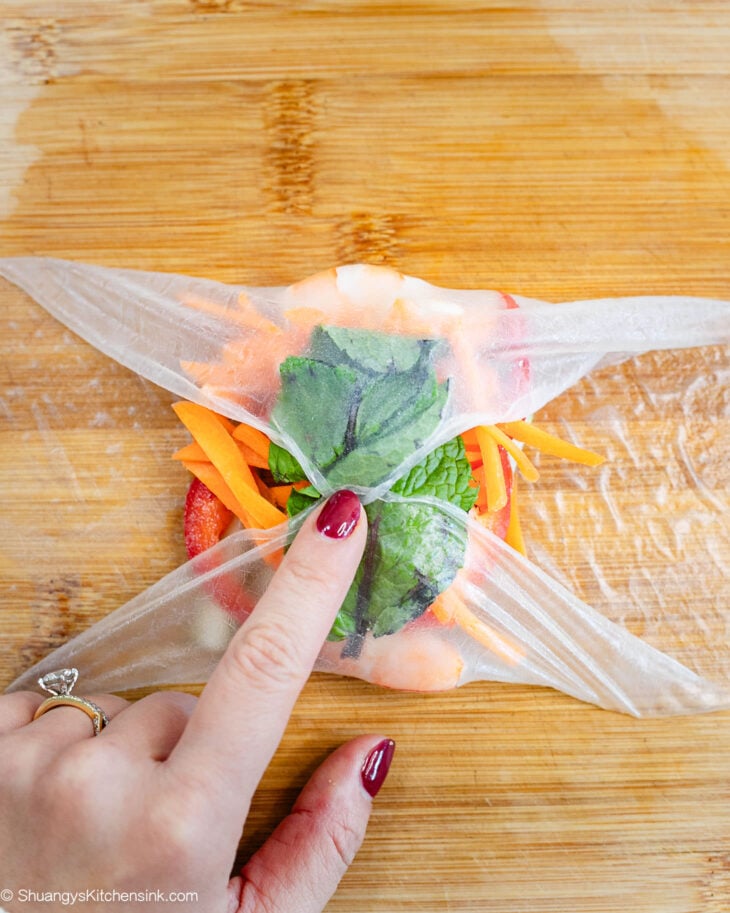 Fold in both sides of the wrapper.