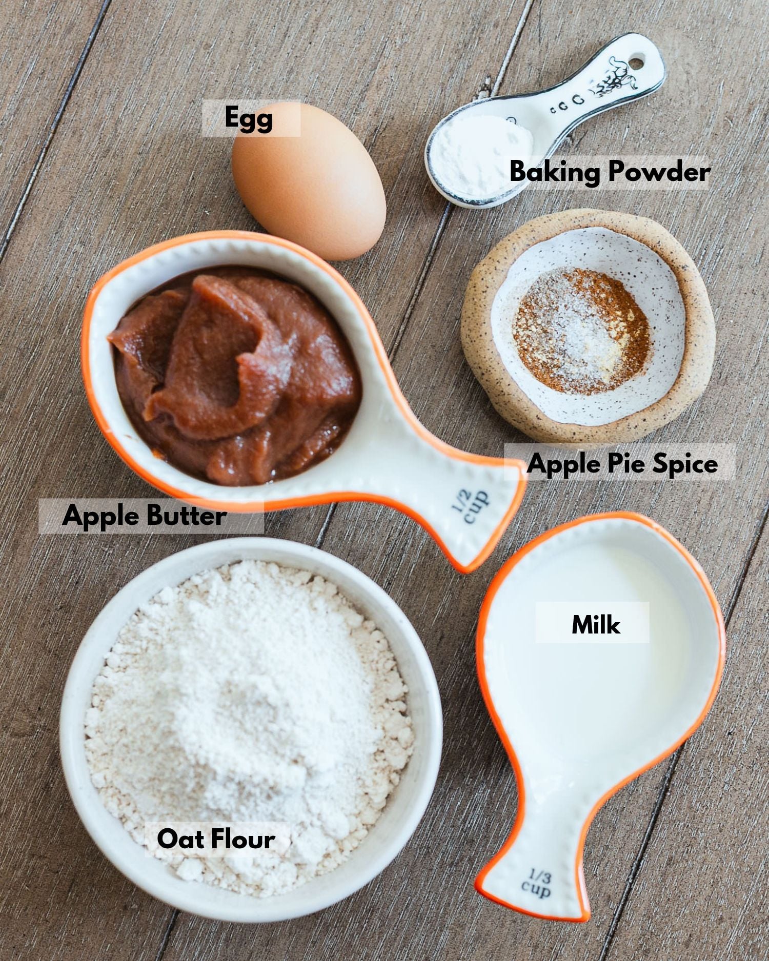 Ingredients for apple butter pancakes: oat flour, apple butter, an egg, milk, baking powder, and apple pie spice