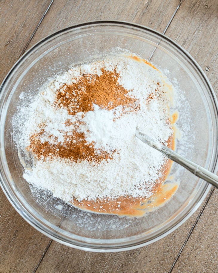 Oat flour, baking powder, and apple pie spice added to the wet ingredients