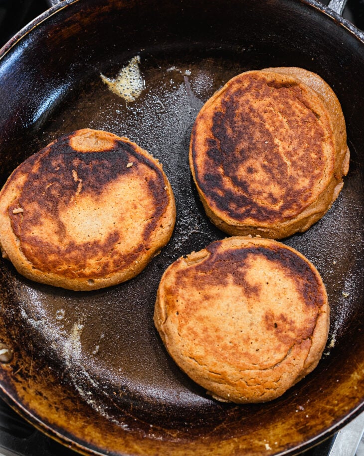 Golden brown apple butter pancakes in a cast iron skillet