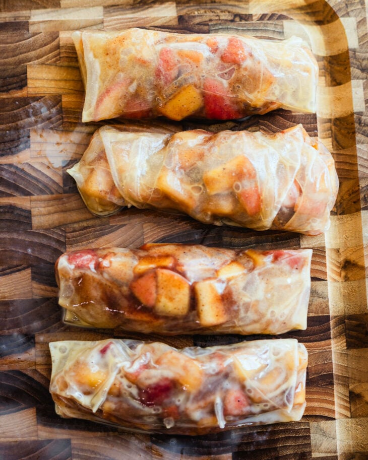 Rice paper folded over apple filling and rolled up tightly like a spring roll