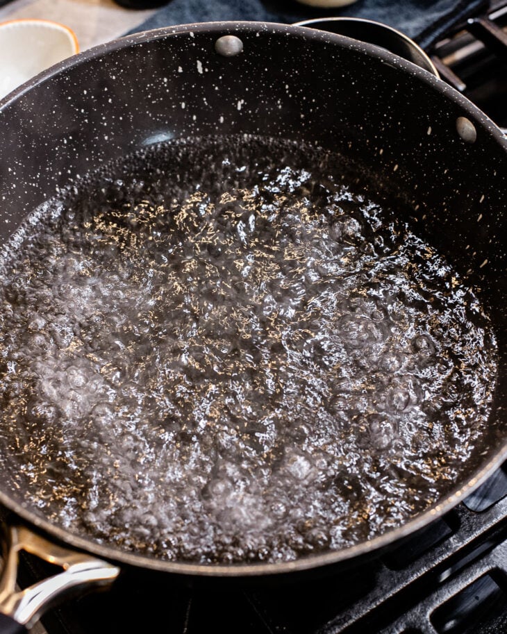 Pot of boiling water with a drizzle of oil